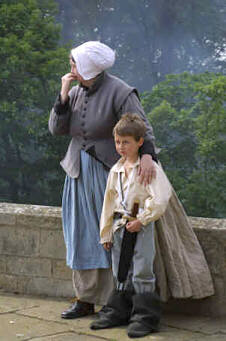 A small boy with his mother, in seventeenth century costume