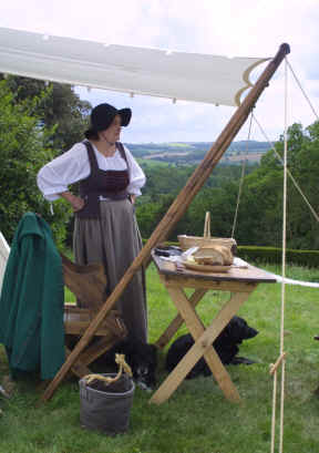 A woman of the camp waits with food for the soldiers