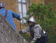 Swordsmen scaling the walls of the castle