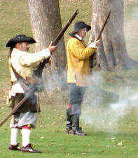Ready ... Aim ... Fire!  Musketeers fire a salvo at the enemy